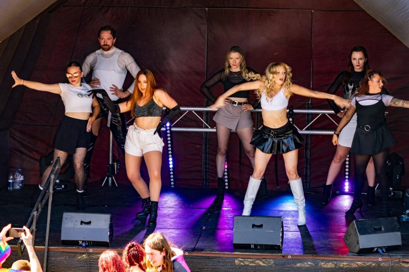 Haus of Heels - 2024 A lively dance performance on stage with multiple dancers in stylish outfits.