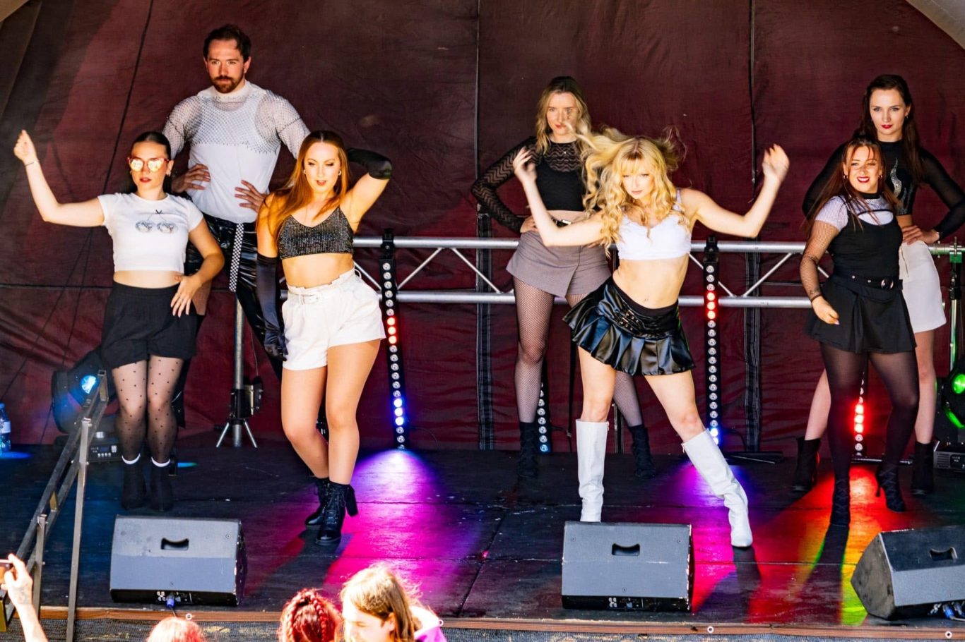 Haus of Heels - 2024 A group of dancers performing energetically on stage at a lively event.
